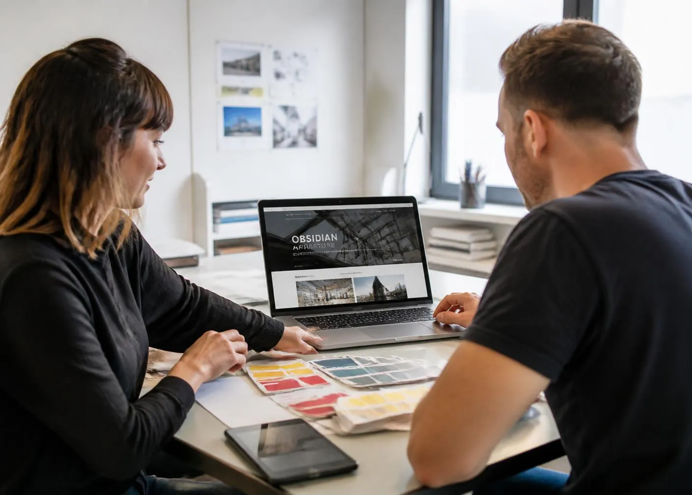 Two designers reviewing an online store layout together on a laptop Two designers reviewing an online store layout together on a laptop